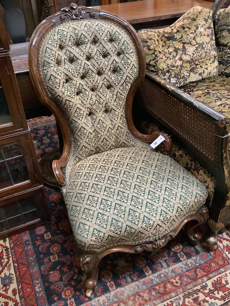 A Victorian carved walnut spoonback nursing chair